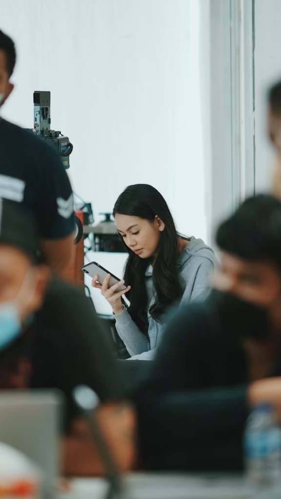 Person on break using their phone to manage money